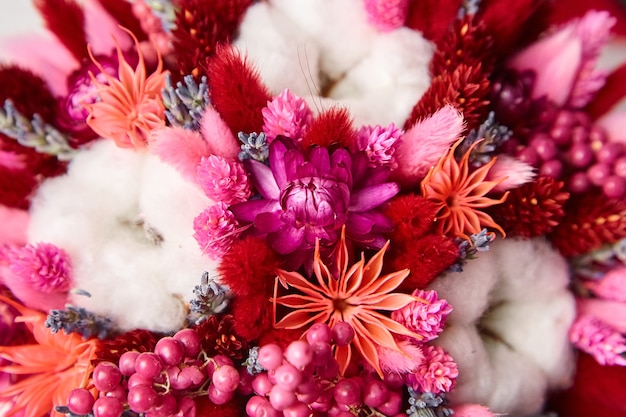 Dried flowers and grasses bouquet with white cotton plant closeup