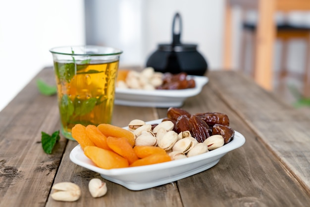 Dried fruit tray with tea glass on wooden background. copy space. close-up view. food.