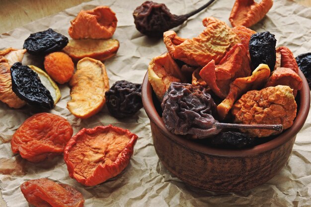 Dried fruits in a cup on paper. Top view.