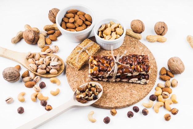 Dried fruits energy bar and ingredients on white background