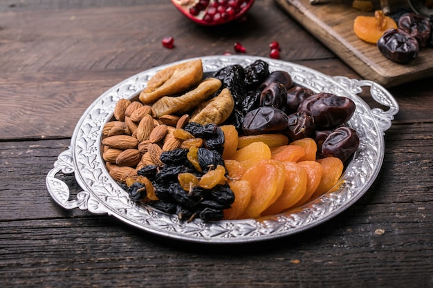 Dried fruits and nuts mix in a wooden bowl