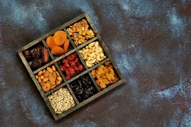 Dried fruits and nuts in a wooden box