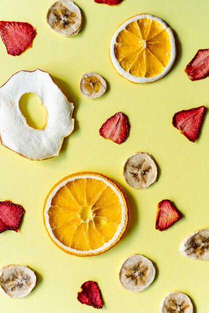 Dried fruits on yellow background