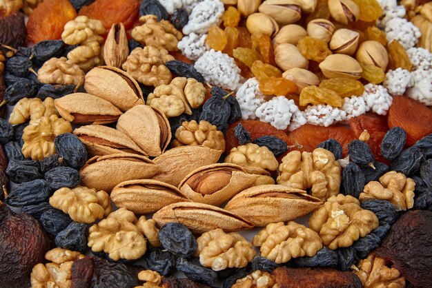 Dried fruits of zucats and nuts are posted on the table. Healthy vegetarian food