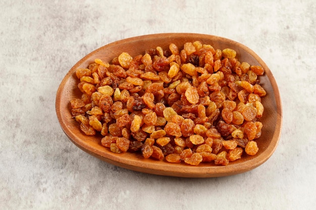 Dried Golden Raisin on Wooden Plate