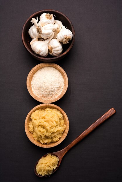 Dried granulated Garlic or Lahsun powder and paste, over moody colourful background. selective focus