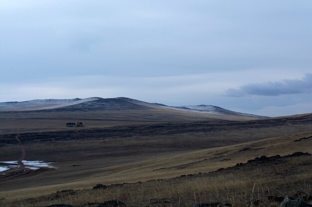 Dried grass field on hill in Siberia, Russia, hill at sunset time