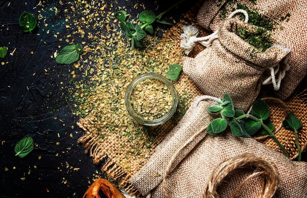 Dried ground oregano or marjoram dark background top view