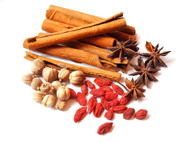 Dried herbs and spices with goji berries, star anise (badiane), cinnamon sticks, amomum testaceum or siam cardamom 