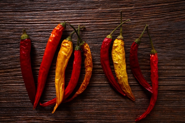 dried hot chili peppers on aged wood