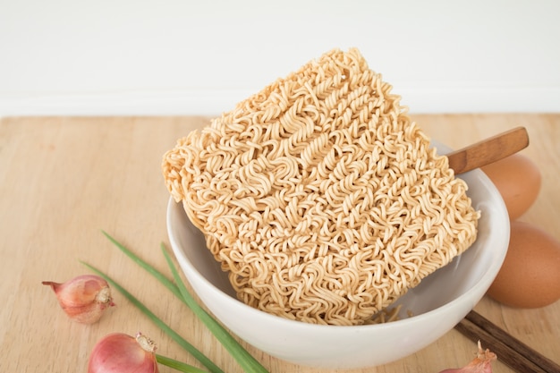 Dried Instant noodle on the wood table.