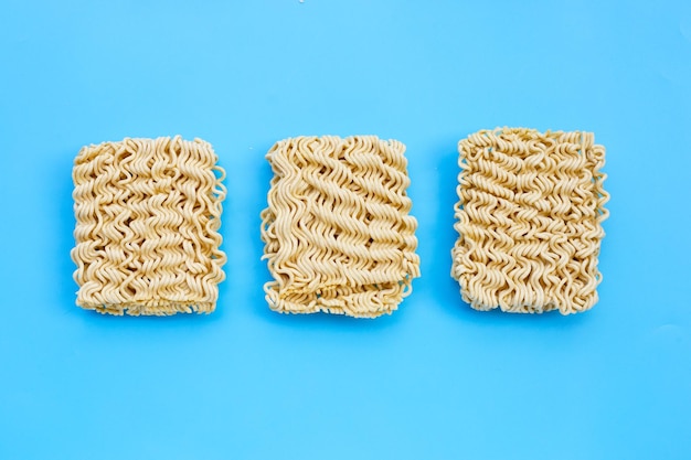 Dried instant noodles on blue background