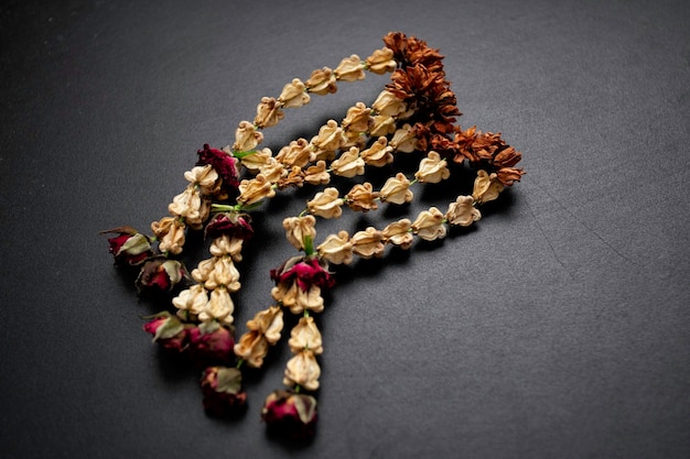 Dried jasmine garland on a black background