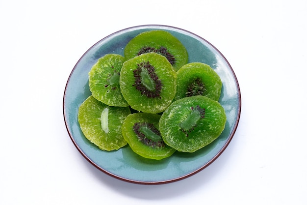 Dried kiwi fruit in plate on white background