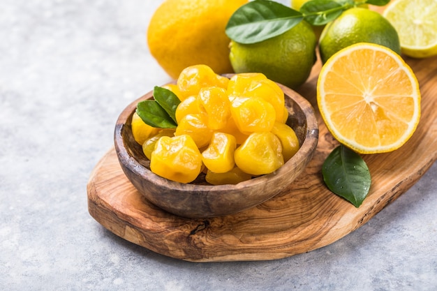 Dried kumquat with orange, lime in bowl