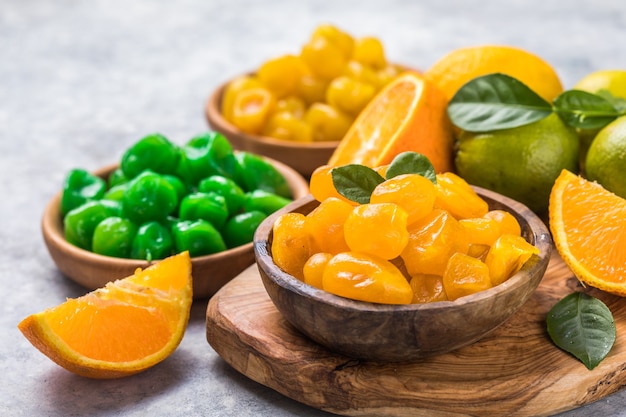 Dried kumquat with orange, lime in bowl