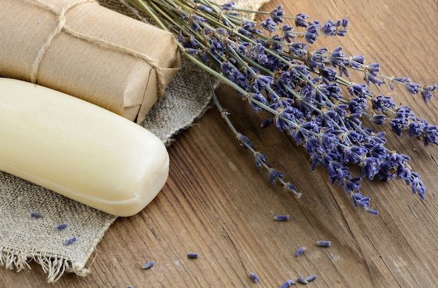 Dried lavender flowers with a soap on a rustic background