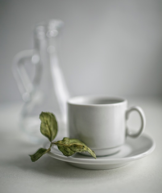 Dried leaves of the Apple tree, lying on a tea saucer next to the carafe