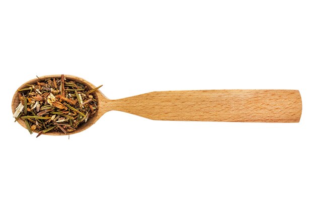 Dried Ledum or Rhododendron subsect in a wooden spoon on a white background.