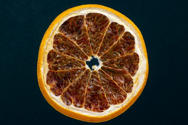 Dried lemon slice on a dark background