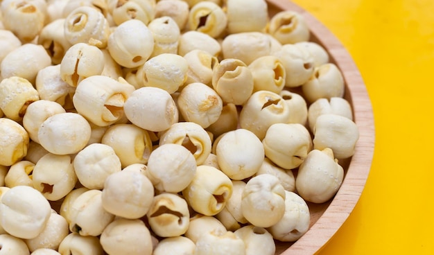 Dried lotus seeds on yellow background