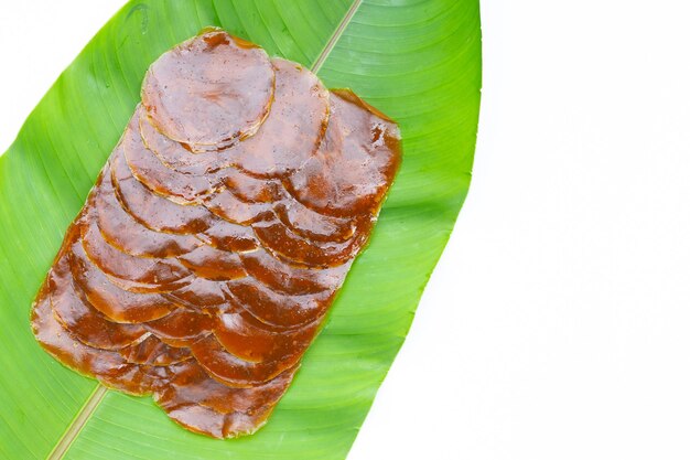 Dried mango paste sheets on green leaf