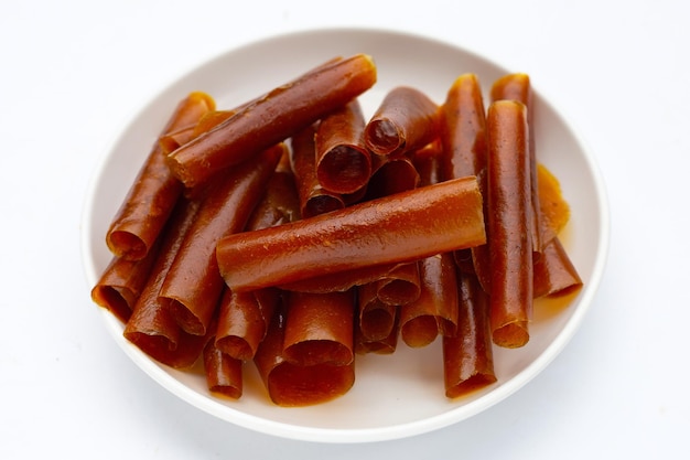 Dried mango paste sheets on white background