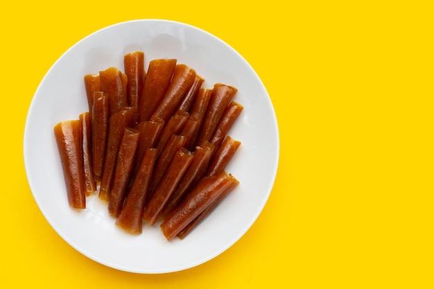 Dried mango paste sheets on white background