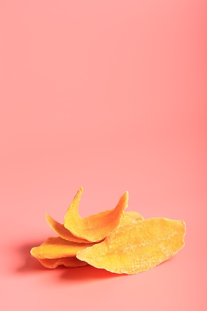 Dried mango on a pink background