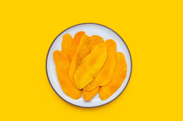 Dried mango on yellow background