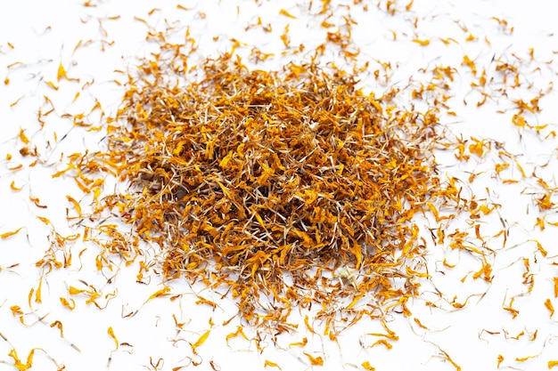 Dried marigold flower petals on white background. Flower herbal tea concept.