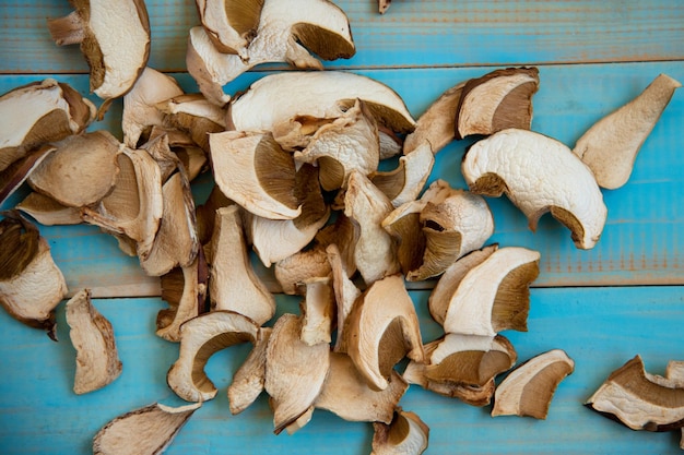 Dried mushrooms, on a blue wooden table. Top view. Copy space. Autumn