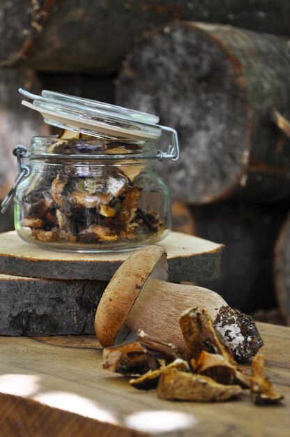 Dried mushrooms in a glass jar on a wooden background