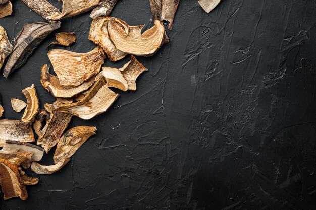 Dried mushrooms set, on black background, top view flat lay , 