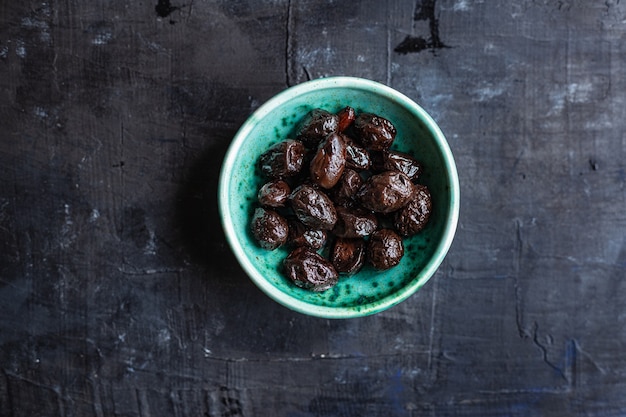 Dried olive sundried olives dry fruit appetizer salad addition on the table