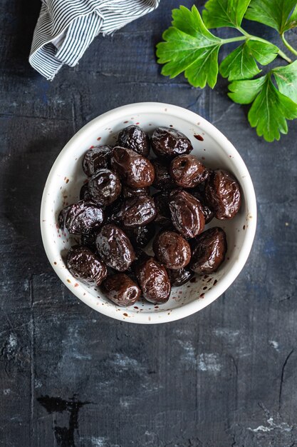 Dried olive sundried olives dry fruit appetizer salad addition on the table