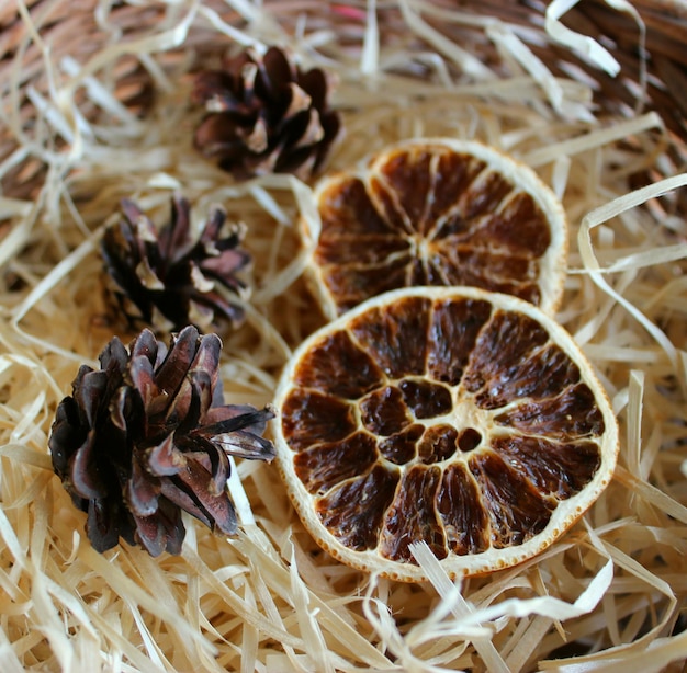 Dried Orange Slices With Dry Pine Cones On A Wood Shavings Closeup Stock Photo