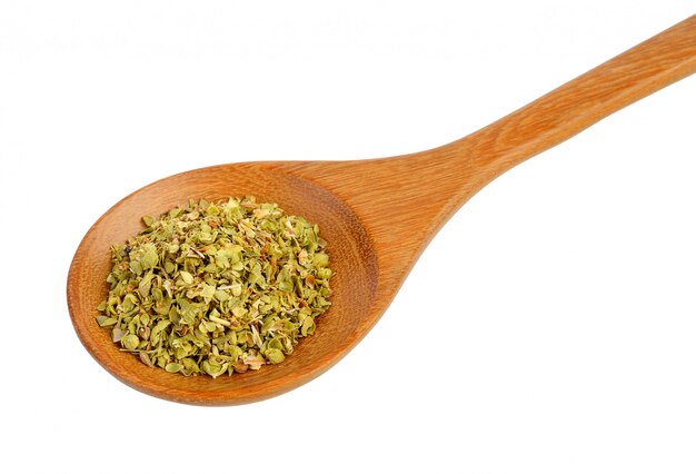 Dried oregano in wood spoon on white isolated