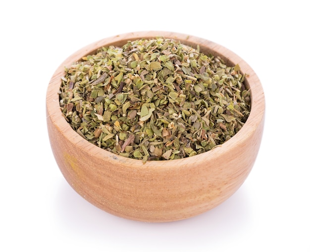 Dried Oregano in wooden bowl on white background