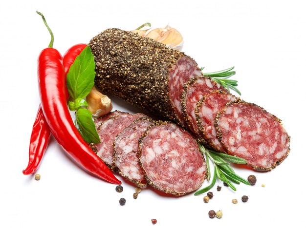 Dried organic salami sausage covered with pepper on white isolated