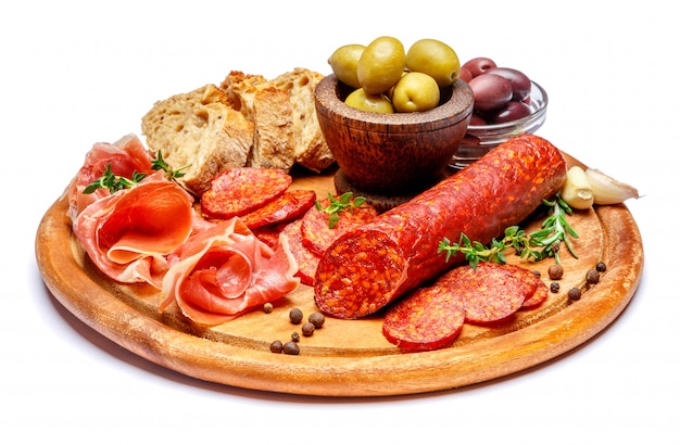 Dried organic salami sausage or spanish chorizo on wooden cutting board