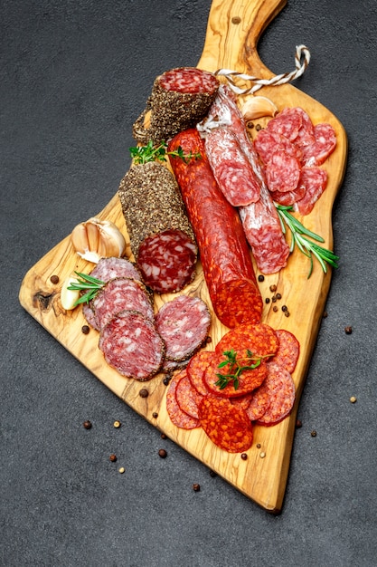 Dried organic salami sausage on wooden cutting board