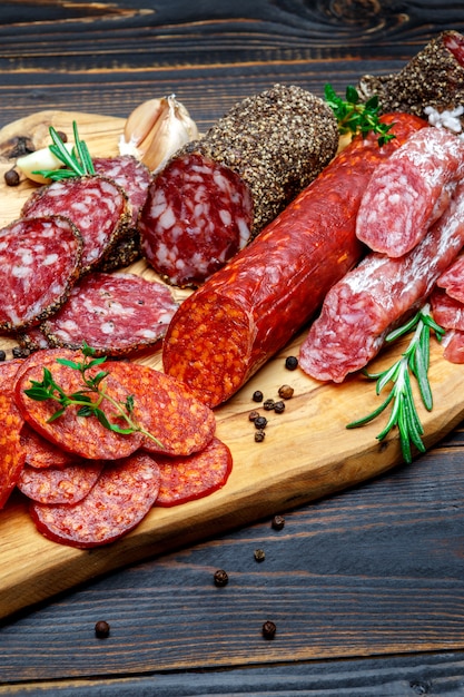 Dried organic salami sausage on wooden cutting board