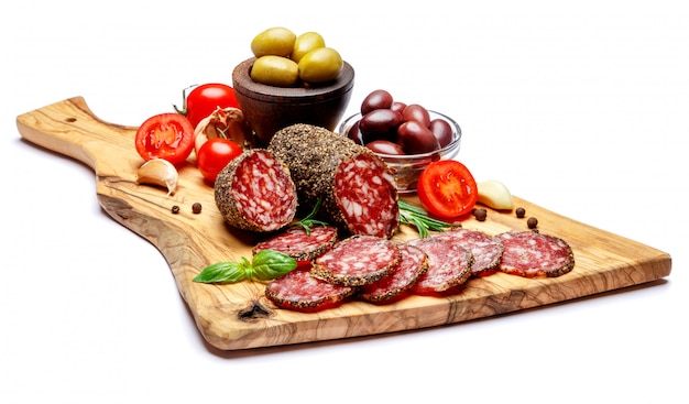 Dried organic salami sausage on wooden cutting board