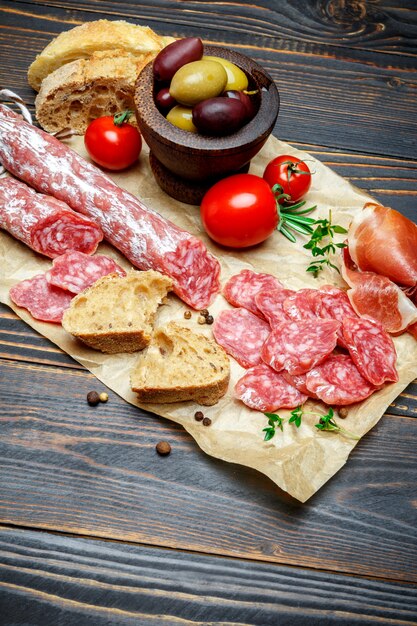 Dried organic salami sausage on wooden table