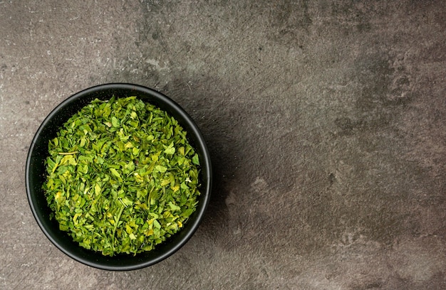 Dried Parsley Leaves from a flatlay angle with a dramatic dark background