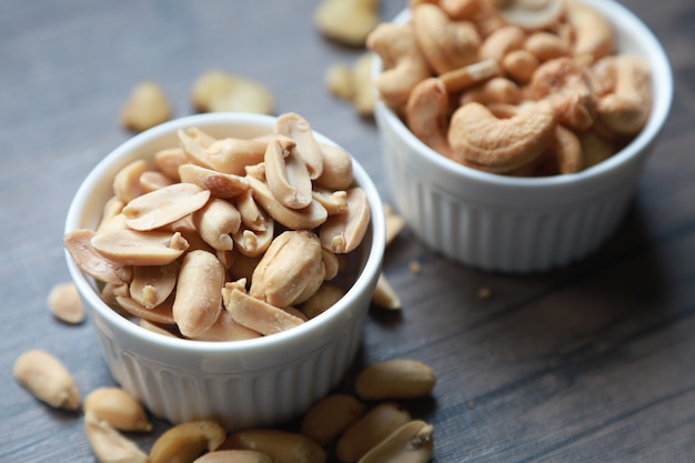 Dried peanuts and cashew on ceramic bowls