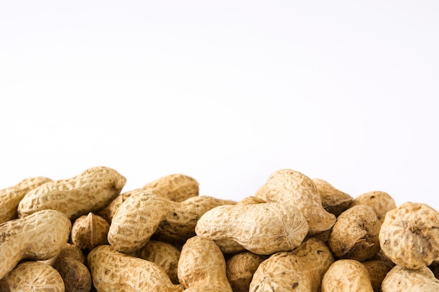 Dried peanuts isolated on white surface Copy space