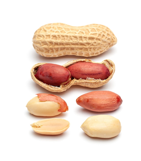 dried peanuts in peel closeup isolated on white background.