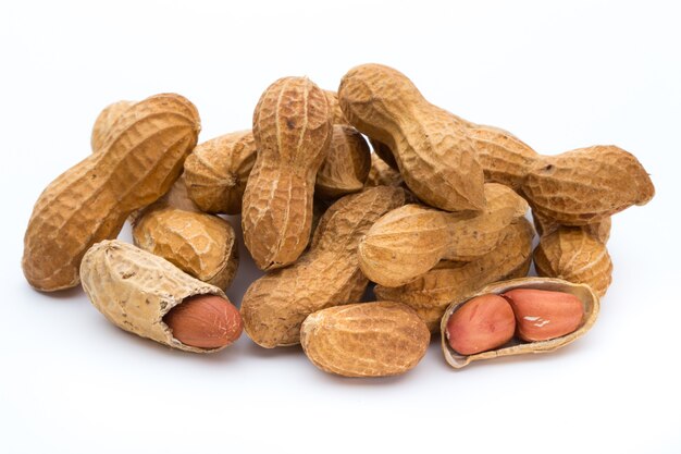 Dried peanuts on white surface